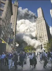  ?? (AP/Amy Sancetta) ?? People flee the falling South Tower of the World Trade Center on Sept. 11, 2001.