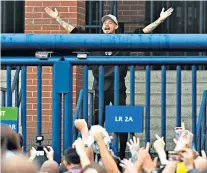  ??  ?? Marching on together: Leeds fans gather to celebrate outside Elland Road last night and are joined by director of football Victor Orta (right) and midfielder Kalvin Phillips (left)