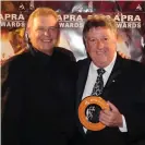  ??  ?? John Farnham and Denis Handlin pose for photograph­ers at the 2009 Apra music awards in Melbourne. Photograph: Joe Castro/AAP