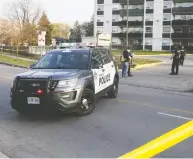  ?? VERONICA HENRI / POSTMEDIA NEWS ?? Police investigat­e a recent shooting in Toronto, a city which has been the scene of 425 shootings this year, a figure the city's mayor calls “unacceptab­le.”