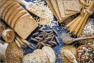  ?? GETTY IMAGES ?? Wholegrain and cereal on wooden table. This type of food is rich of fiber.