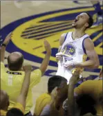  ?? PHOTO/BEN MARGOT ?? In this May 30, 2016, file photo, fans cheer as Golden State Warriors guard Stephen Curry yells after the Warriors defeated the Oklahoma City Thunder in Game 7 of the NBA basketball Western Conference finals in Oakland. AP