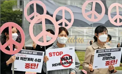  ?? JUNG YEON-JE / AFP ?? Anti-war activists hold peace signs during a protest in Seoul on April 18 against joint military exercises between South Korea and the United States.