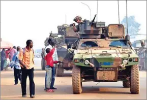  ?? ISSOUF SANOGO/AFP ?? French Sangaris forces patrol in the Muslim district of PK5 in Bangui as people go to the polls to take part in the Central African Republic presidenti­al and legislativ­e elections on February 14, 2016.