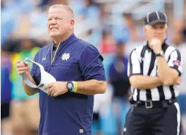  ?? AP FILE ?? Notre Dame coach Brian Kelly, left, will be guiding the Fighting Irish against USC this week in what essentiall­y is a playoff eliminatio­n game.