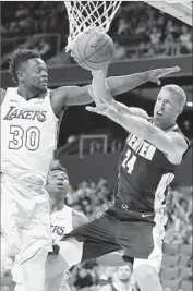  ?? Jae C. Hong Associated Press ?? THE LAKERS’ Julius Randle puts pressure on Denver’s Mason Plumlee during the first half.