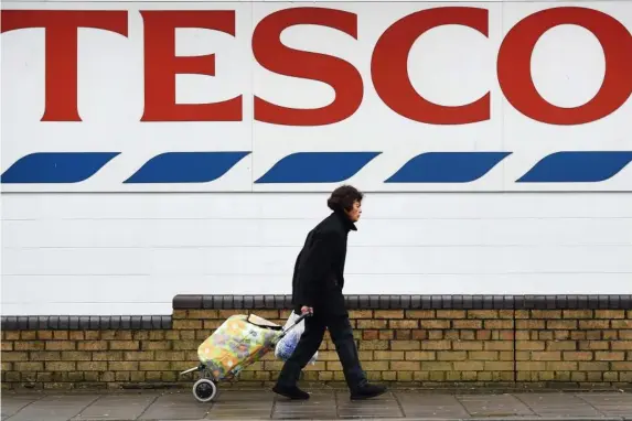  ?? (EPA) ?? Unhappy shopper: Tesco axed 4,500 jobs last August, mostly in its Metro stores