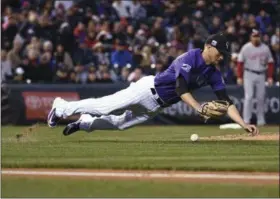  ?? JOHN LEYBA - THE ASSOCIATED PRESS ?? Colorado Rockies starting pitcher Kyle Freeland knocks down the ball on a hit by Washington Nationals’ Victor Robles during the third inning of a baseball game Friday, Sept. 28, 2018, in Denver. Robles was safe at first on the play.