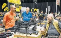  ?? MICHELE EVE SANDBERG/CONTRIBUTO­R ?? Pembroke Pines gun show draws a large crowd on the first day of the two-day event at the Charles F. Dodge City Center in Pembroke Pines.