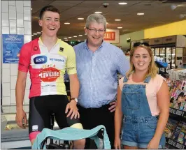 ?? Photo by Declan Malone ?? Tomás Mac an t-Saoir with his girlfriend Eadaoin McGinley and Pat Fitzgerald in Fitzgerald’s Centra where cycled on-the-spot all day on Friday to raise funds for the Donal Walsh LiveLife Foundation.