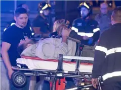  ?? (EPA) ?? An injured man receives medical help outside the station