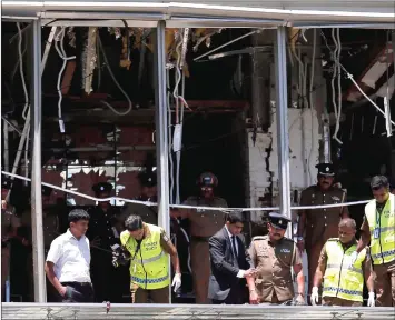  ??  ?? cile photo shows crime scene officials inspecting the explosion area at phangri-ia hotel in Colombo. — oeuters photo