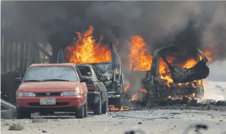  ??  ?? Vehicles burn after a bomb explosion outside the Save the Children offices in Jalalabad