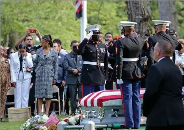  ??  ?? marine honor guard members salute after placing the casket at the graveside service on tuesday.