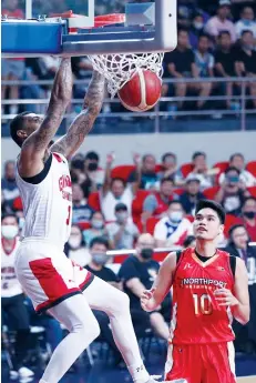  ?? (PBA photo) ?? Barangay Ginebra San Miguel Kings' Jamie Malonzo scores on a two-handed as NorthPort Batang Pier's Arvin Tolentino looks on.
