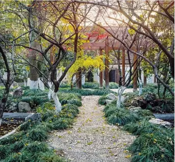  ??  ?? The garden walkway of Mu Xin’s former residence in Wuzhen, Zhejiang Province — Courtesy of Mu Xin Art Museum