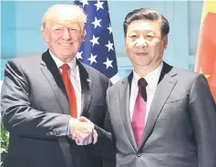  ??  ?? Trump and Xi shake hands prior to a meeting on the sidelines of the G20 Summit in Hamburg, Germany. — AFP photo