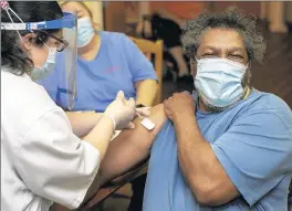  ?? MICHAEL GARD/POST-TRIBUNE ?? Ervin Scales gets the COVID-19 vaccine Monday at AHEPA Senior Apartments in Merrillvil­le.