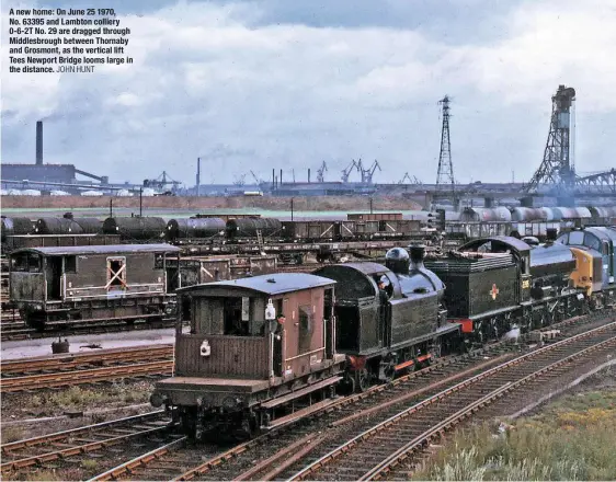  ?? JOHN HUNT ?? A new home: On June 25 1970, No. 63395 and Lambton colliery 0‑6‑2T No. 29 are dragged through Middlesbro­ugh between Thornaby and Grosmont, as the vertical lift Tees Newport Bridge looms large in the distance.