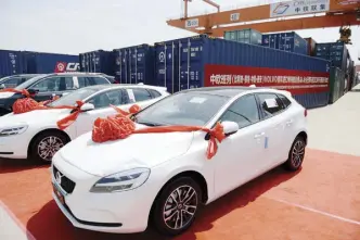  ??  ?? 160 imported European-made cars transporte­d by a China Railway Express train arrive at Xi’an Vehicle Port, June 13. The train set off from Ghent in Belgium and traveled for 16 days and more than 10,000 kilometers.