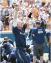  ?? SARTIN/AP RANDY ?? Notre Dame’s Jack Brannigan waves to fans as teammates celebrate behind him after defeating Tennessee on Sunday.