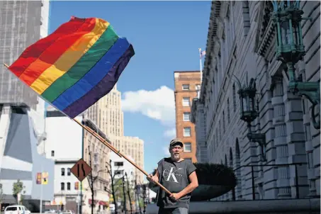  ?? Justin Sullivan / Getty Images ?? Bob Sodervick waves a gay pride flag outside of the Ninth U.S. Circuit Court of Appeals, which won’t rehear the Prop. 8 case.