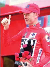  ?? — AFP photo ?? Sky's British cyclist Christophe­r Froome celebrates retaining the red jersey on the podium of the 18th stage of the 72nd edition of “La Vuelta” Tour of Spain cycling race, a 169 km route from Suances to Santo Toribio de Liebana, near Potes, on...