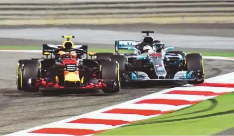  ?? AFP ?? Red Bull’s Max Verstappen (left) brushes past Mercedes’ Lewis Hamilton as they come round a corner during the Bahrain Grand Prix at the Sakhir Circuit in Manama on Sunday.