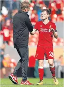  ??  ?? Jurgen Klopp congratula­tes Andrew Robertson after his fine performanc­e.