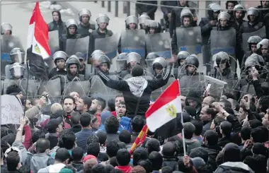  ??  ?? Riot police stand guard in Cairo on Thursday as protesters condemn the deaths of 74 people in riots on Wednesday.