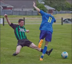  ??  ?? Denis McAuliffe of Arklow United tackles Wicklow Town’s Patrick Murphy.