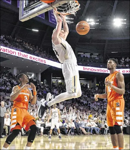  ?? CONTRIBUTE­D BY JOHN AMIS ?? Ben Lammers dunks in front of Syracuse’s Andrew White III (3) and Taurean Thompson. The 6-foot-10 Georgia Tech center had 23 points, seven blocks and seven rebounds in the win.