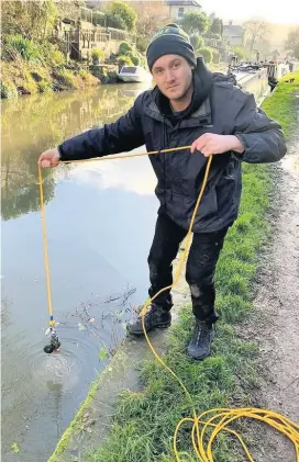  ??  ?? Toby Scott with the suspected grenade attached to the magnet line