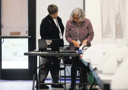  ?? MELISSA MELVIN-RODRIGUEZ mrodriguez@charlotteo­bserver.com ?? Election official Kay Patterson, left, looks through paperwork with site coordinato­r Frankie Jenkins at Eastway Regional Recreation­al Center in Charlotte on Feb. 28.