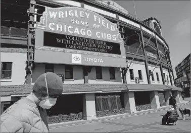  ?? NAM Y. HUH/AP PHOTO ?? In this April 16 file photo, Wrigley Field’s marquee displays Lakeview Pantry volunteer informatio­n in Chicago.