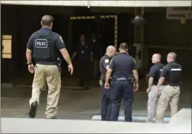  ?? BEN HASTY - MEDIANEWS GROUP ?? Law enforcemen­t personnel gather at the Berks County Services Center in Reading Monday afternoon, Aug. 12, after responding to a Berks County deputy sheriff’s apparently accidental, self-inflicted gun shot wound in the adjoining courthouse.