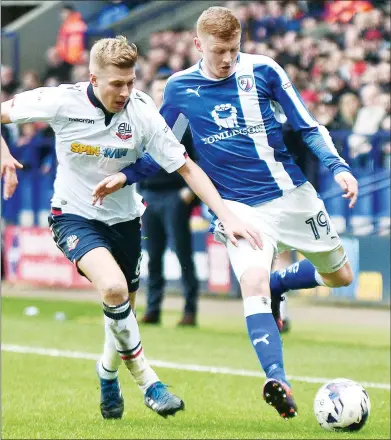  ??  ?? HANDS OFF: Chesterfie­ld’s Dion Donohue shrugs off Josh Vela at the Macron Stadium