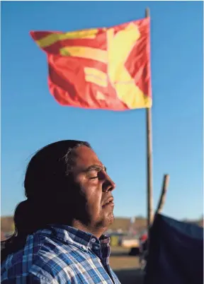  ?? JOSH MORGAN FOR THE (SIOUX FALLS, S.D.) ARGUS LEADER ?? Alphonse LeRoy of the Yankton Sioux Nation, a seventhgen­eration pipe carrier who has been hit by rubber bullets and pepperspra­yed during protests, stands outside one of the tribe’s campsites near Cannon Ball, N.D.