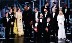  ?? AP PHOTO BY CHRIS PIZZELLO ?? Jordan Horowitz, foreground center, and the cast of "La La Land" mistakenly accept the award for best picture at the Oscars on Sunday at the Dolby Theatre in Los Angeles. It was later announced that "Moonlight," was the winner for best picture.