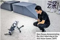  ?? ?? Qian Xiaoyu demonstrat­ing the Lite3 robot dog at the 2022 Asian Games. (AFP)
