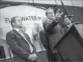  ?? JAKE MAY, THE ASSOCIATED PRESS ?? Michigan Attorney General Bill Schuette announces charges Wednesday in Flint, Mich. Five people, including the head of Michigan’s health department, were charged.