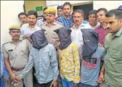  ?? HT PHOTO ?? Police with the men arrested on Monday for murder and robbery in Mansarovar area of Jaipur.