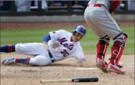  ?? JULIE JACOBSON - THE ASSOCIATED PRESS ?? New York Mets’ Michael Conforto (30) slides safely into home plate to score on a double by Brandon Nimmo during the eighth inning of a baseball game against the Cincinnati Reds, Wednesday, Aug. 8, 2018, in New York. The Mets won 8-0.