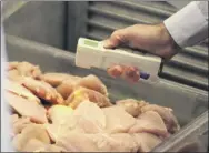  ?? Paul Buckowski / Times Union archive ?? A senior public health technician with Albany County Health Department checks the temperatur­e of chicken in a cooler during his inspection of the Albany Marriott kitchen.