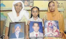  ?? BHARAT BHUSHAN/HT ?? (From left) Jaspal Kaur, her granddaugh­ter Amarpreet and daughterin­law Rajbir Kaur holding photograph­s of their family members in Fatehgarh Sahib.