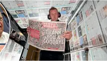  ?? ?? Nick Taylor examines a copy of the very last issue of News of The World in July 2011.