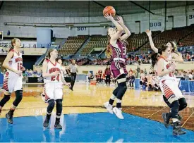  ??  ?? Cashion’s Sydney Manning, center, goes to the basket during Friday’s state semifinal game against Howe at the Big House. Cashion beat Howe to advance to the Class 2A finals.