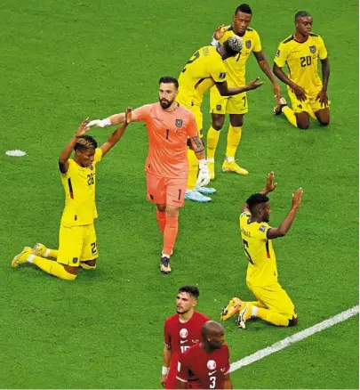  ?? — AFP ?? Joy and despair: ecuador players celebrate as two crestfalle­n Qatar players leave the pitch after the opening Group a match at the al-bayt Stadium.