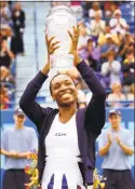  ?? Melanie Stengel / New Haven Register file photo ?? Venus Williams, a four-time champion, hoists the winners trophy after defeating Lindsay Davenport in the final of the 2002 Pilot Pen tournament.