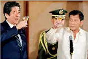  ??  ?? Japanese PM Shinzo Abe, left, and Philippine’s Rodrigo Duterte toast during a state banquet in Manila — AP